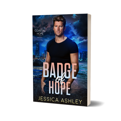 Book cover of 'Badge of Hope' by Jessica Ashley with a person standing in front of a city skyline at night.