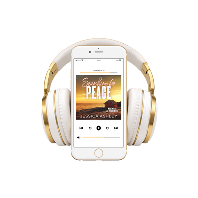 White and gold headphones with a smartphone displaying an audiobook titled 'Searching for Peace' by Jessica Ashley.